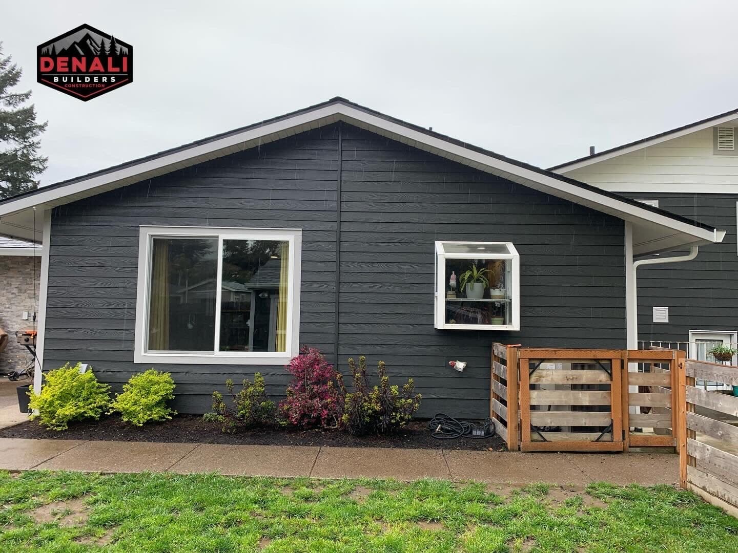 Dark siding and white window trim on residential remodel in Portland Oregon